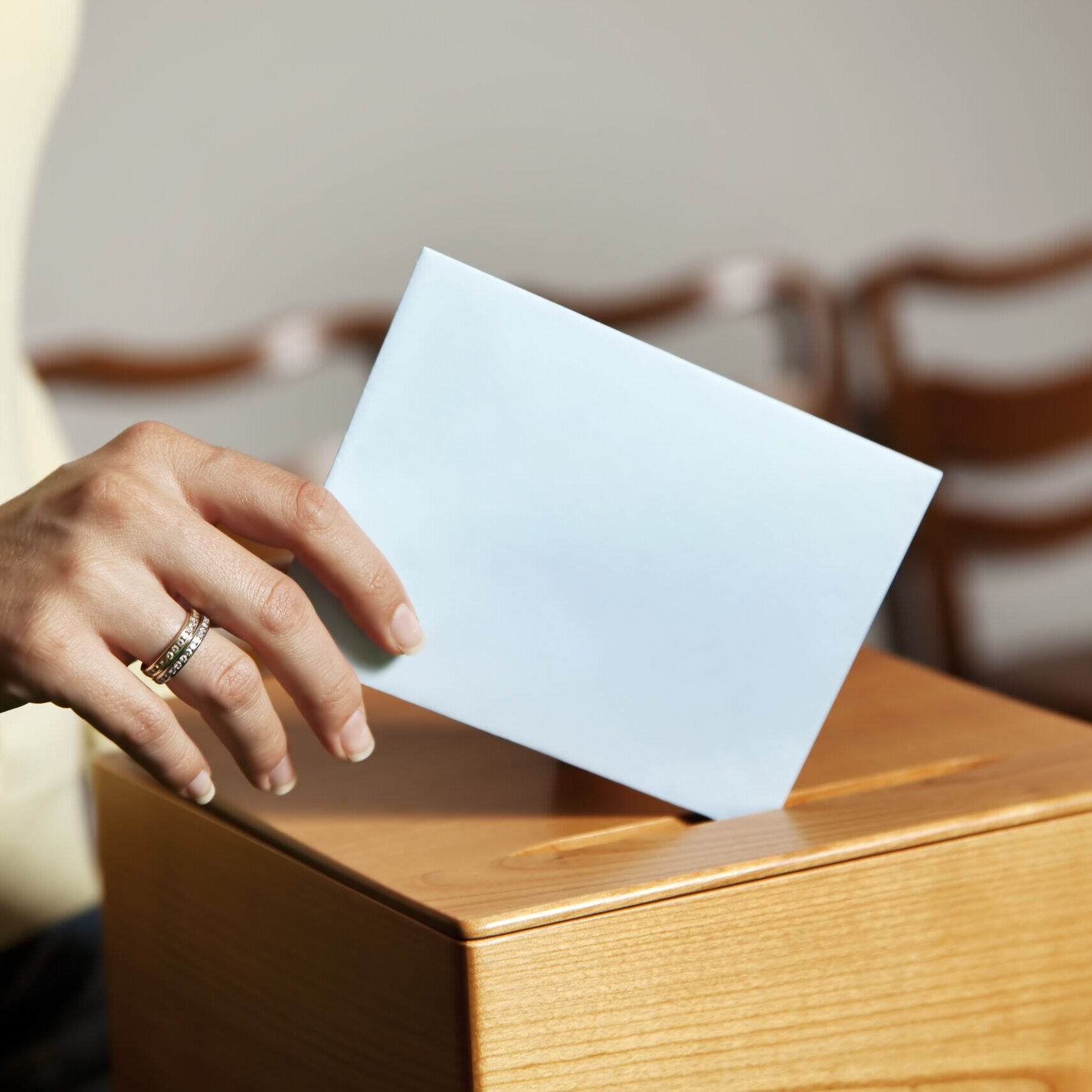 a young woman with a voter in the voting booth. voting in a democracy